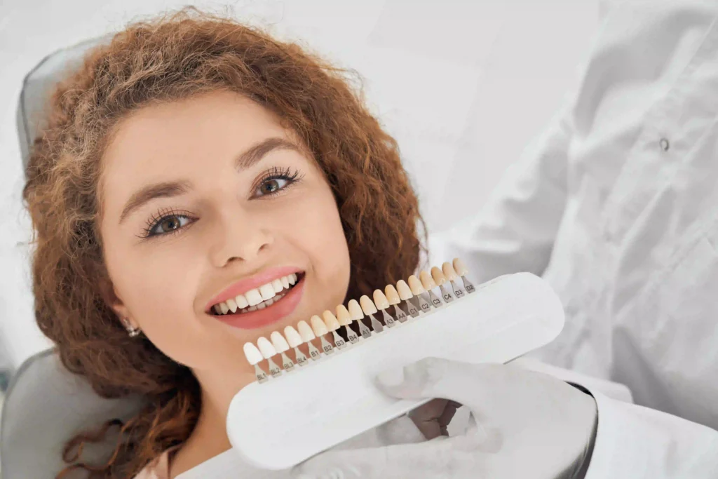 woman smiling while male dentist keeping teeth color range ezgif.com optiwebp